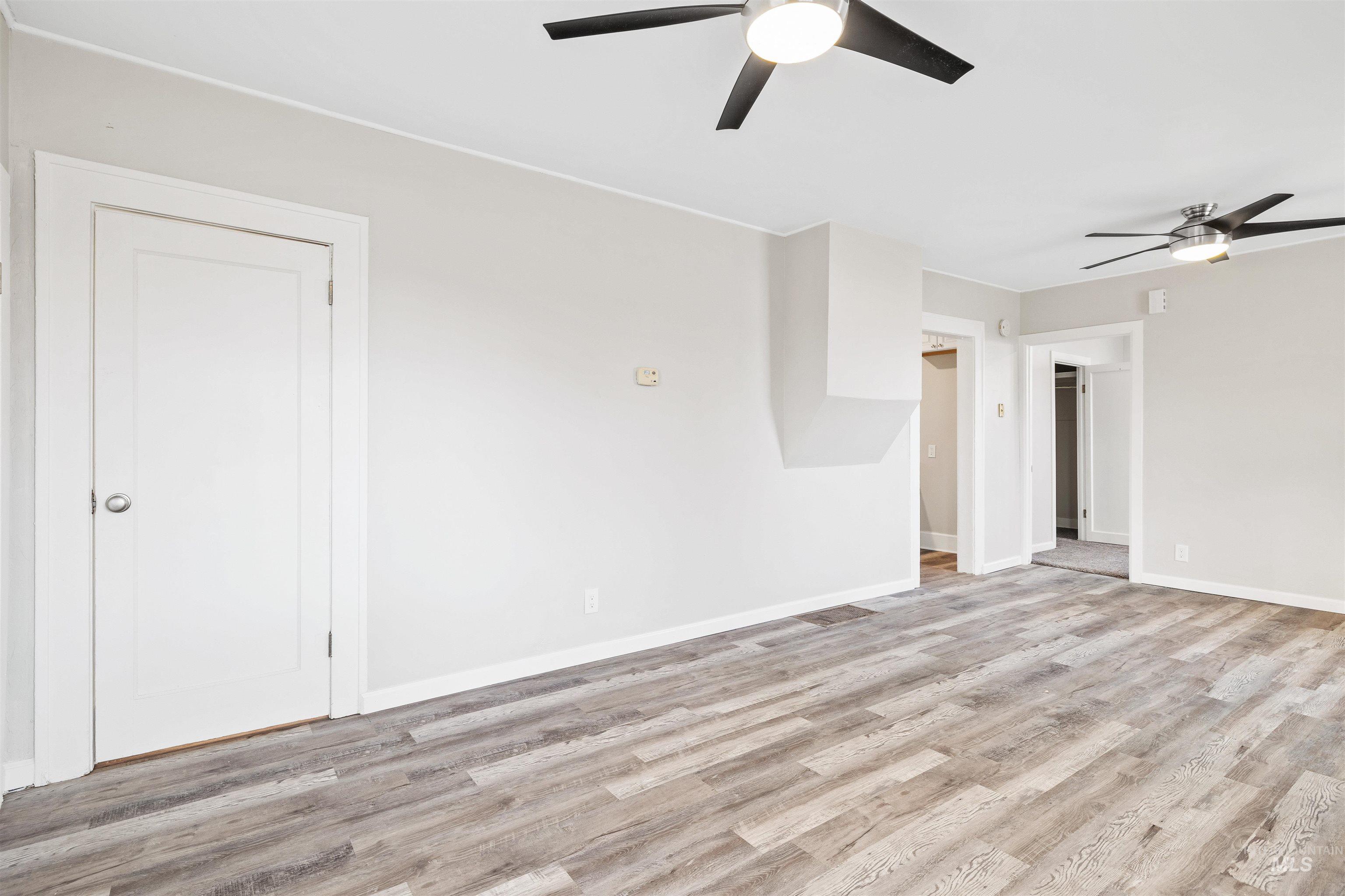 617 Eden Street North Twin Falls, ID 83301 - Photo 6 of 25 Unfurnished living room with ceiling fan and light wood-style flooring