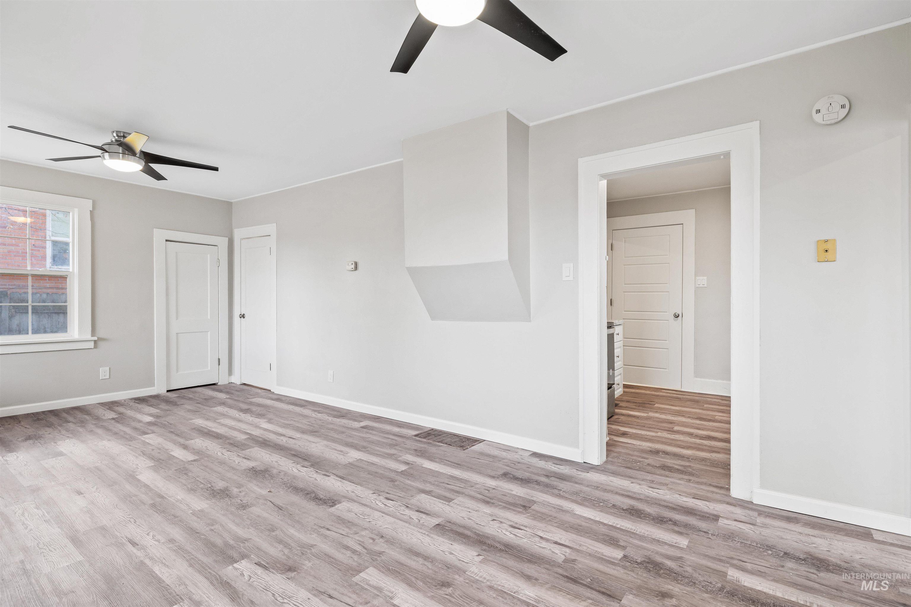 617 Eden Street North Twin Falls, ID 83301 - Photo 7 of 25 Empty room featuring a ceiling fan and light wood finished floors