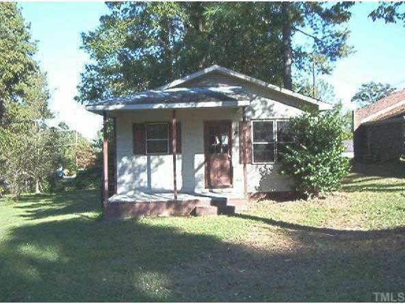 a view of a house with backyard porch and sitting area