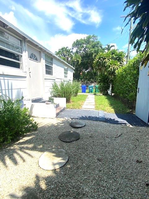 2952 Virginia Street Miami, FL 33133 - Photo 5 of 10 a view of a white house with a yard and sitting area