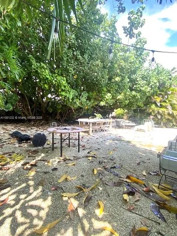 a view of backyard with a table and chairs