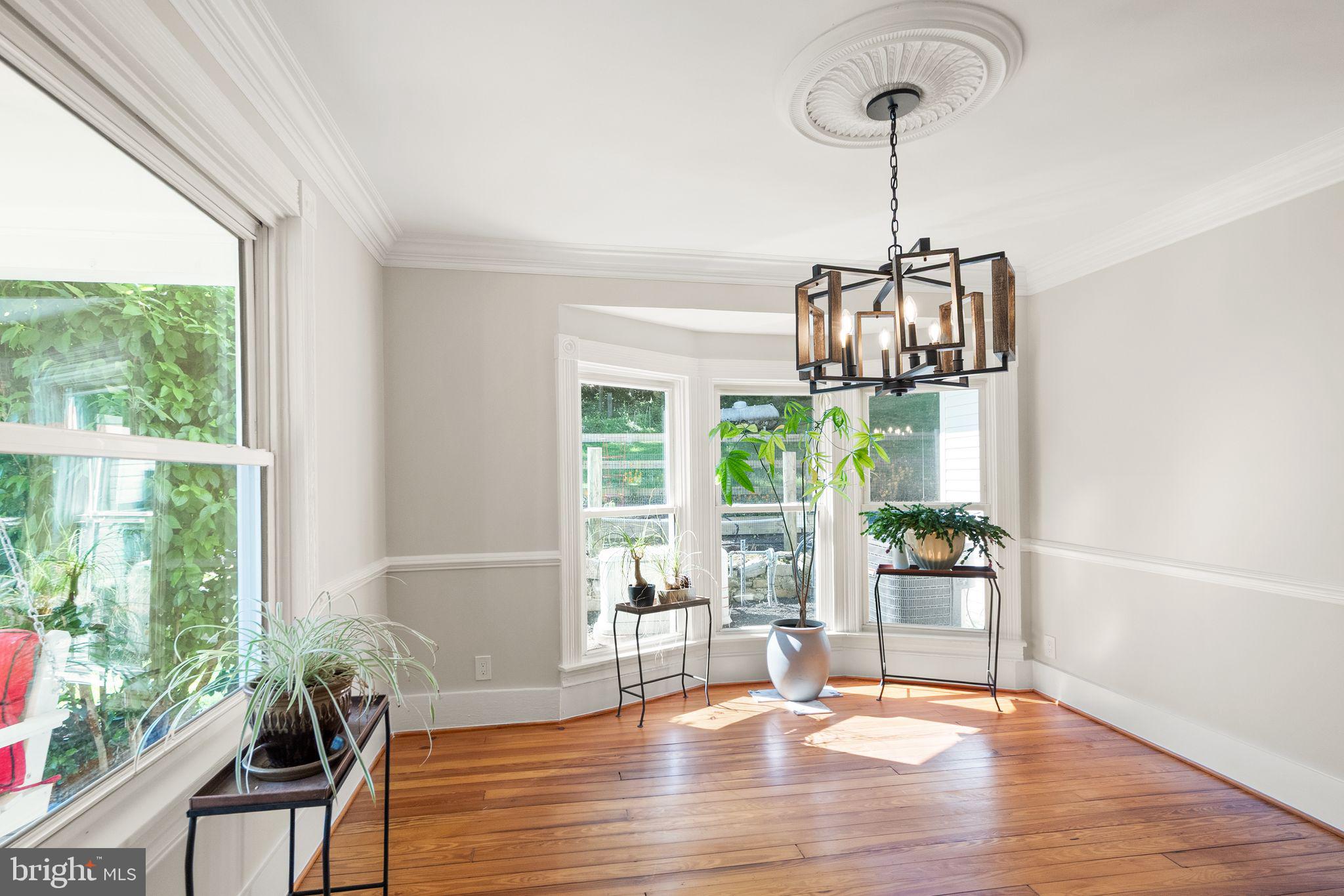 37151 Branchriver Road Purcellville, VA 20132 - Photo 10 of 63 a dining room with wooden floor a chandelier