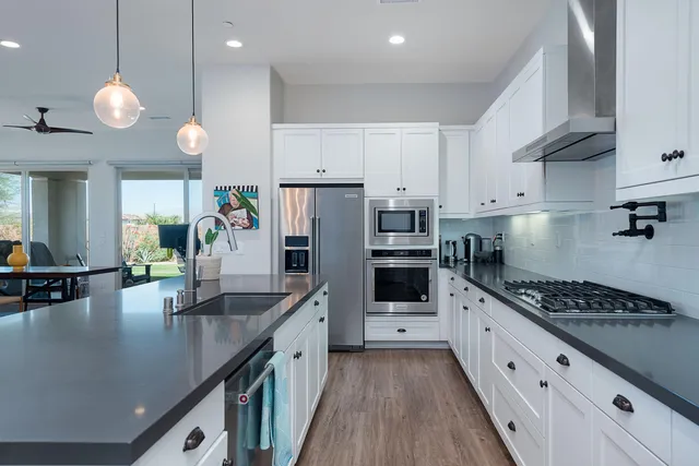 a kitchen with refrigerator and cabinets