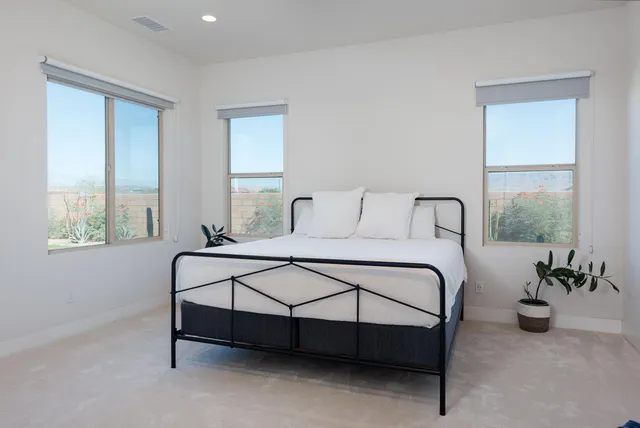 a bedroom with a bed and window