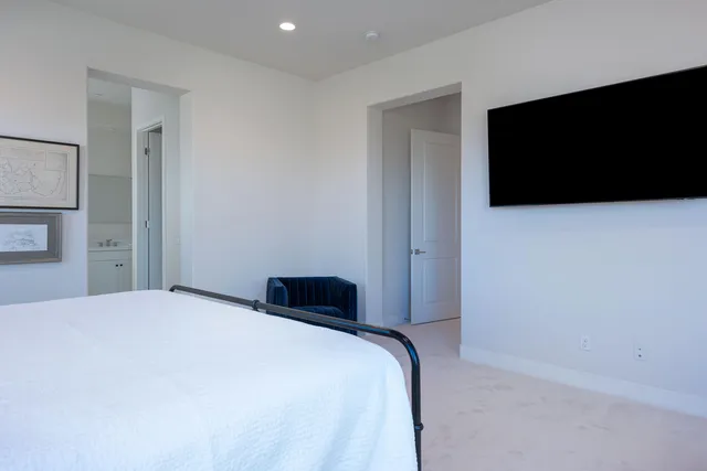 a bedroom with a bed and a flat screen tv