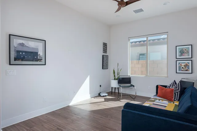 a living room with furniture and wooden floor