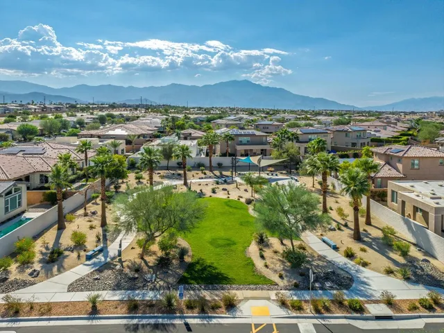 a view of a city with lots of residential buildings ocean and mountain view in back