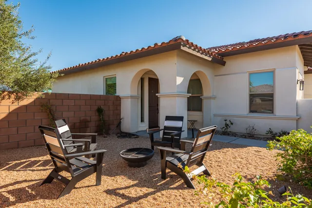 a view of a house with backyard and sitting area