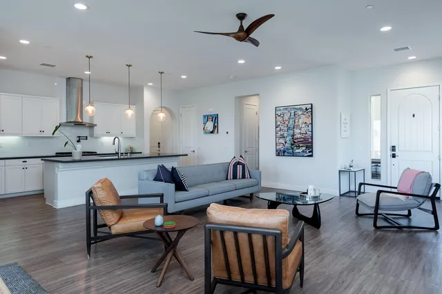 a living room with furniture and kitchen view