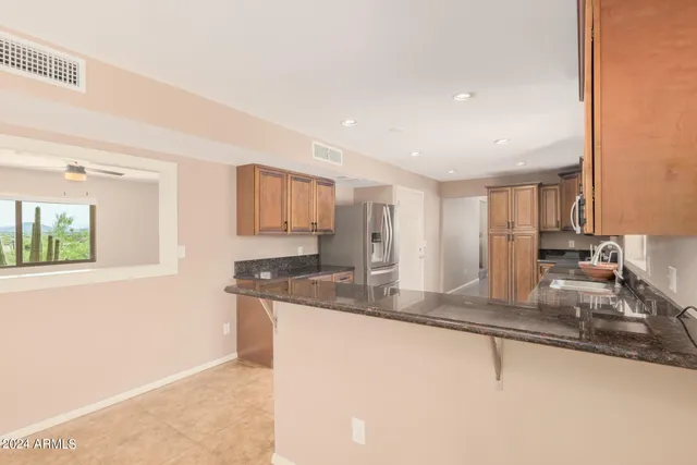 a kitchen with stainless steel appliances granite countertop a sink and a granite counter tops