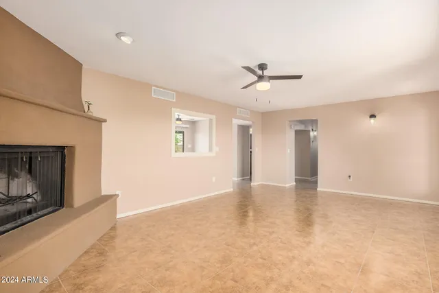 a view of an empty room with a fireplace