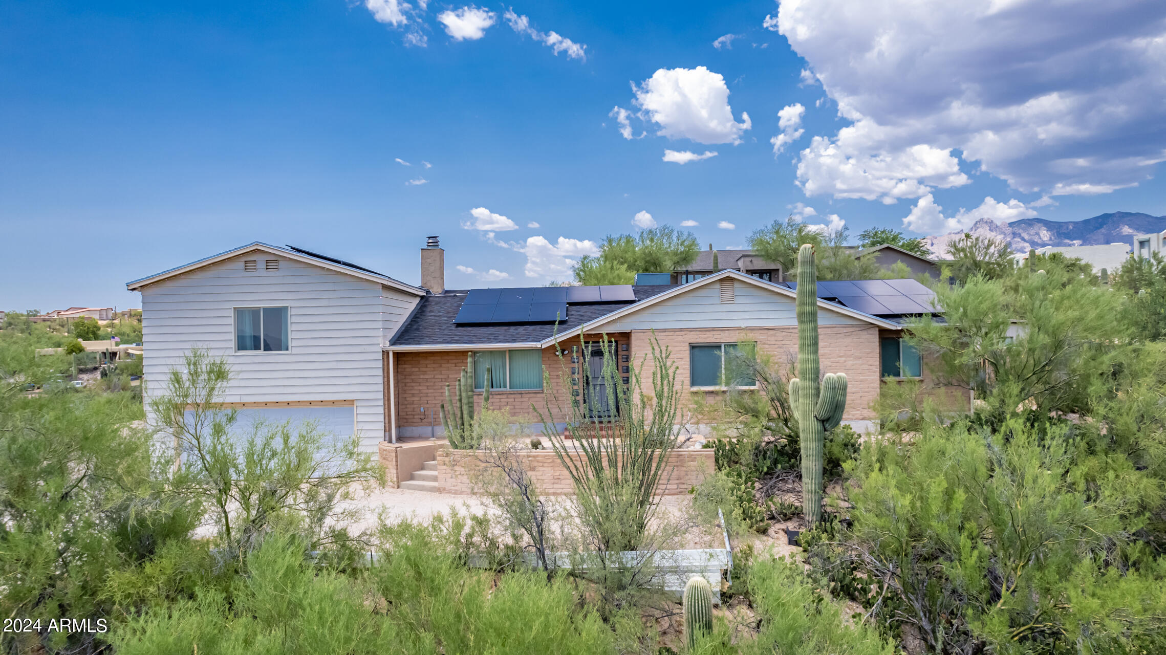 4980 North Hillcrest Drive Tucson, AZ 85704 - Photo 2 of 33 a view of a house with a yard and potted plants