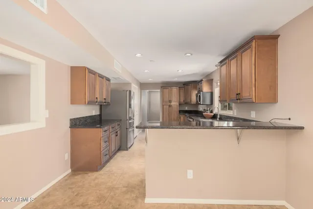 a large kitchen with stainless steel appliances lots of counter top space