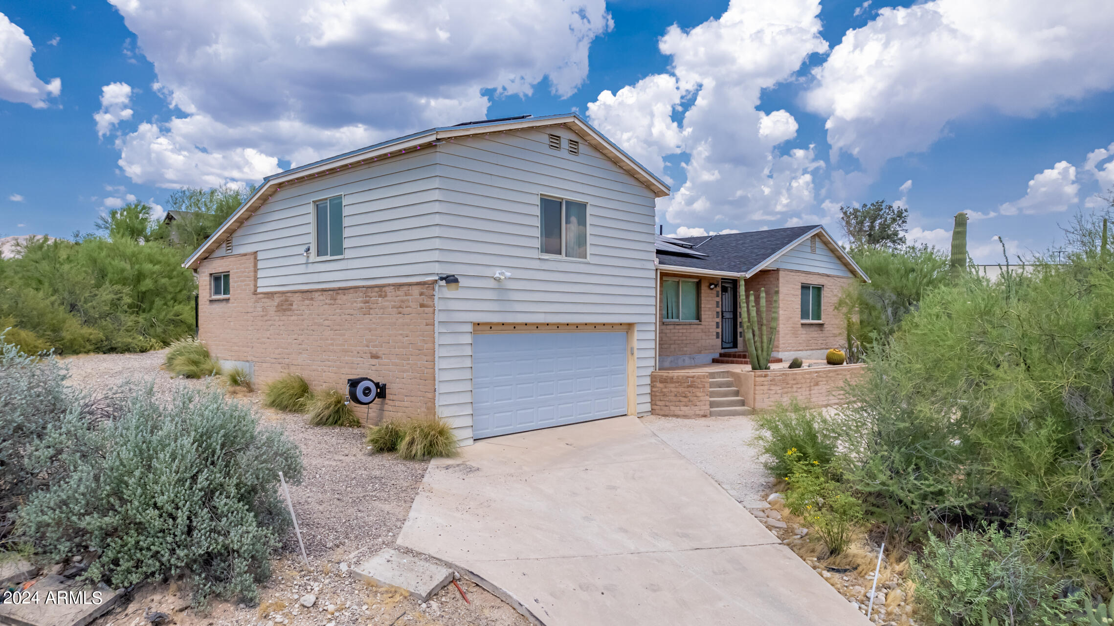 4980 North Hillcrest Drive Tucson, AZ 85704 - Photo 4 of 33 a front view of a house with garden
