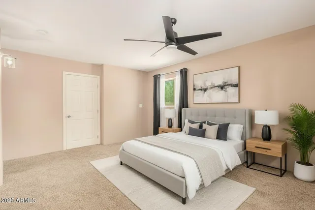 a bedroom with a large bed and a chandelier