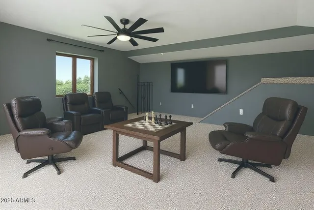 a living room with furniture and a ceiling fan