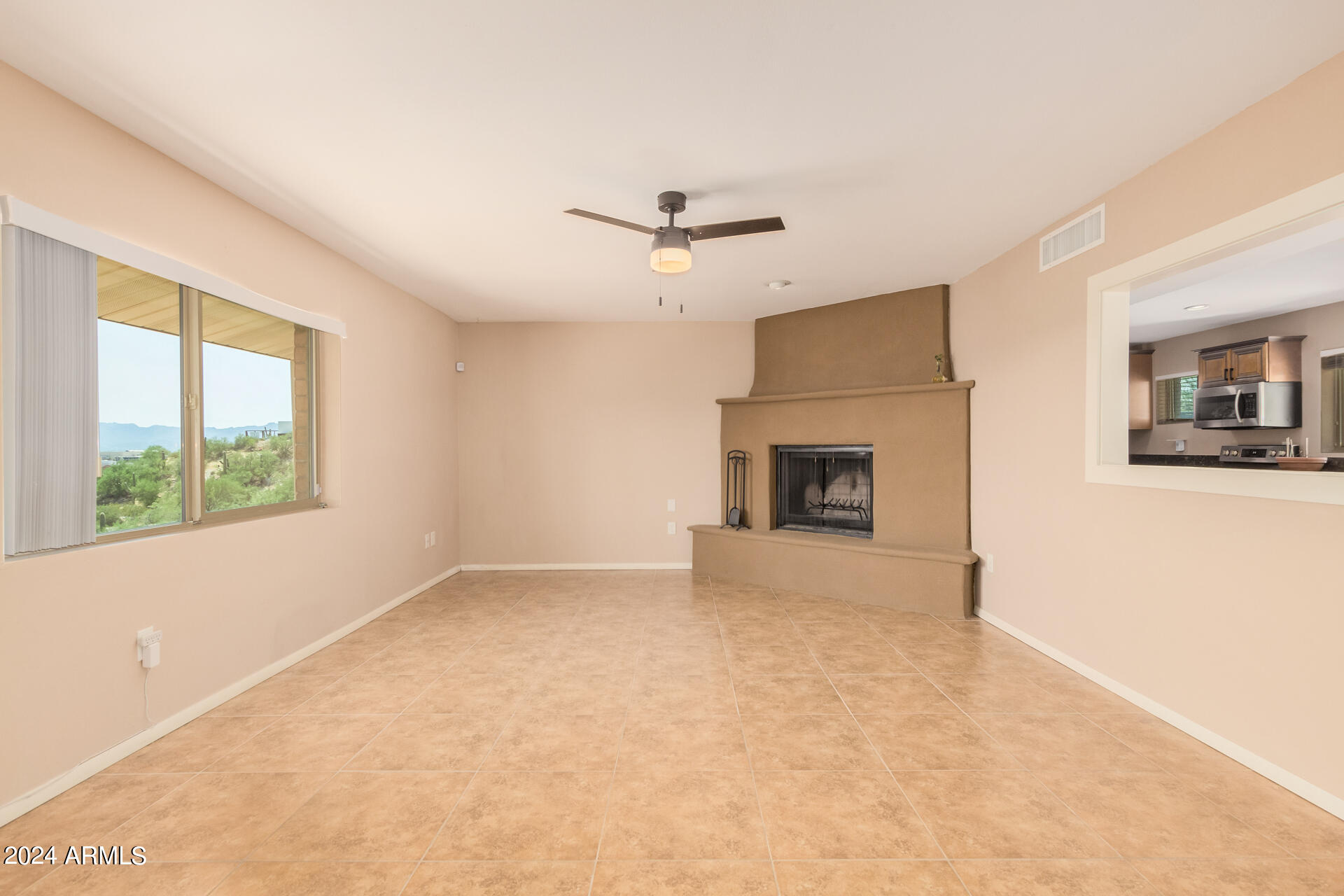 4980 North Hillcrest Drive Tucson, AZ 85704 - Photo 7 of 33 an empty room with windows and fireplace