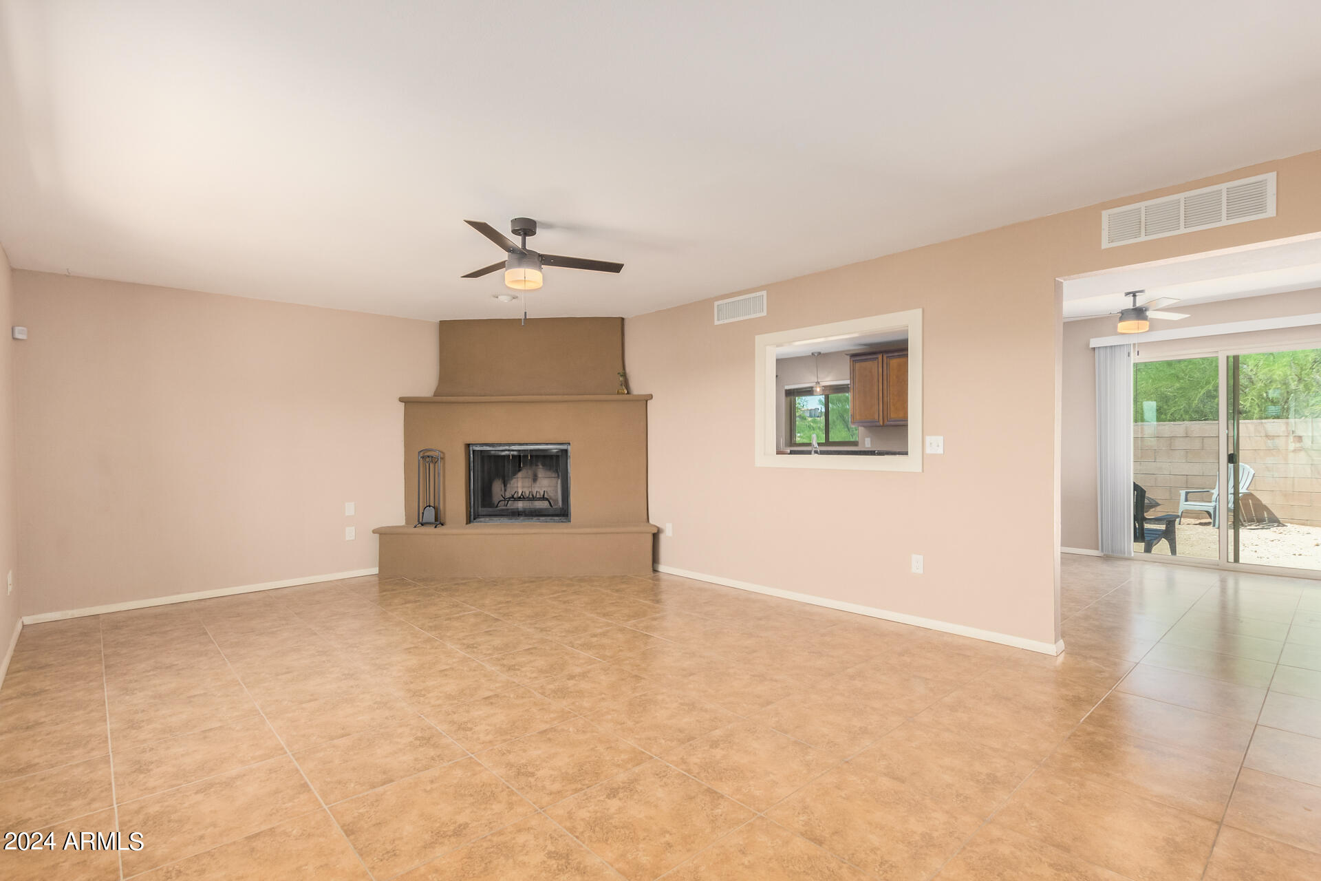 4980 North Hillcrest Drive Tucson, AZ 85704 - Photo 8 of 33 an empty room with windows and fireplace
