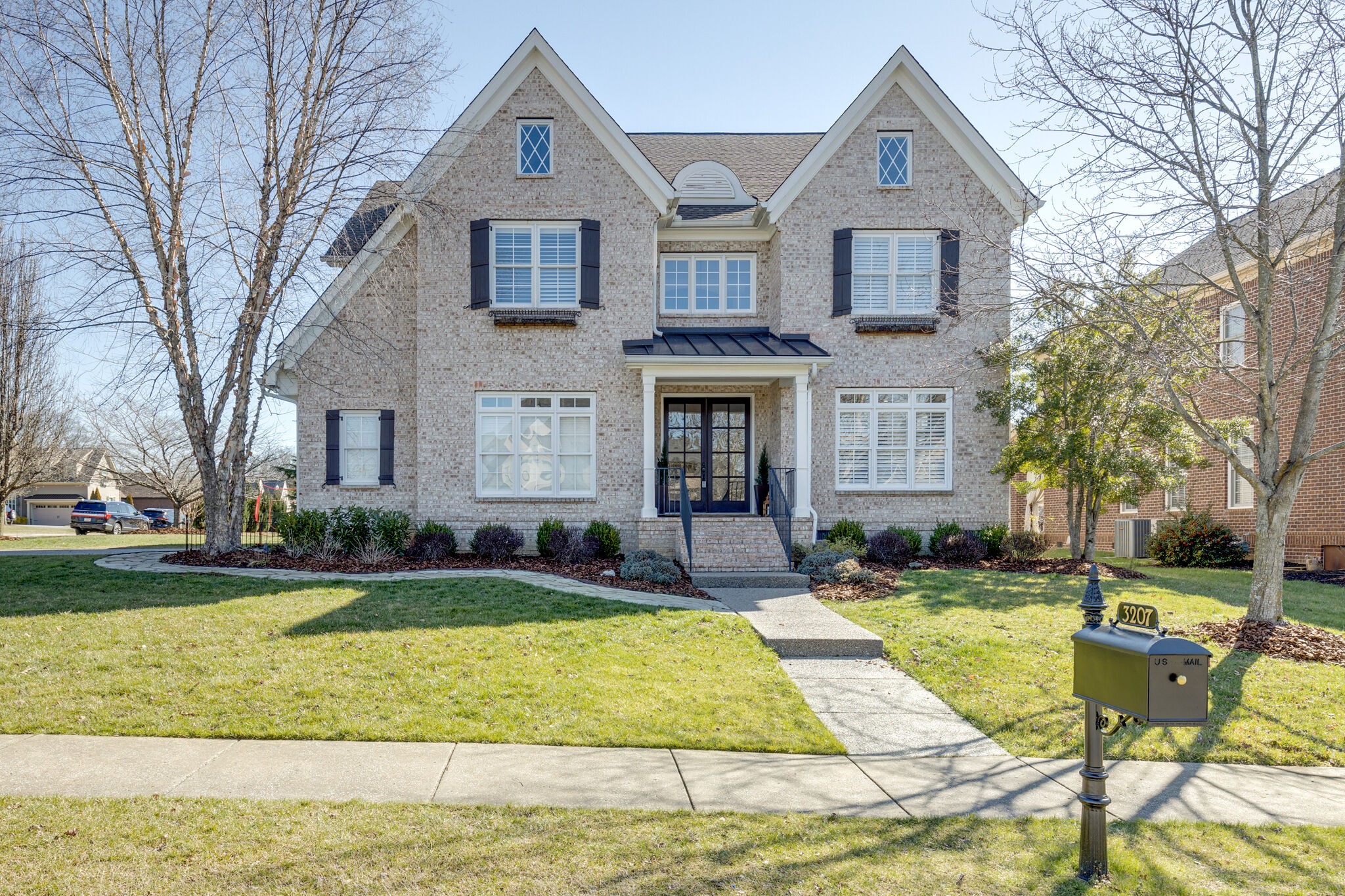 a front view of house with yard and green space