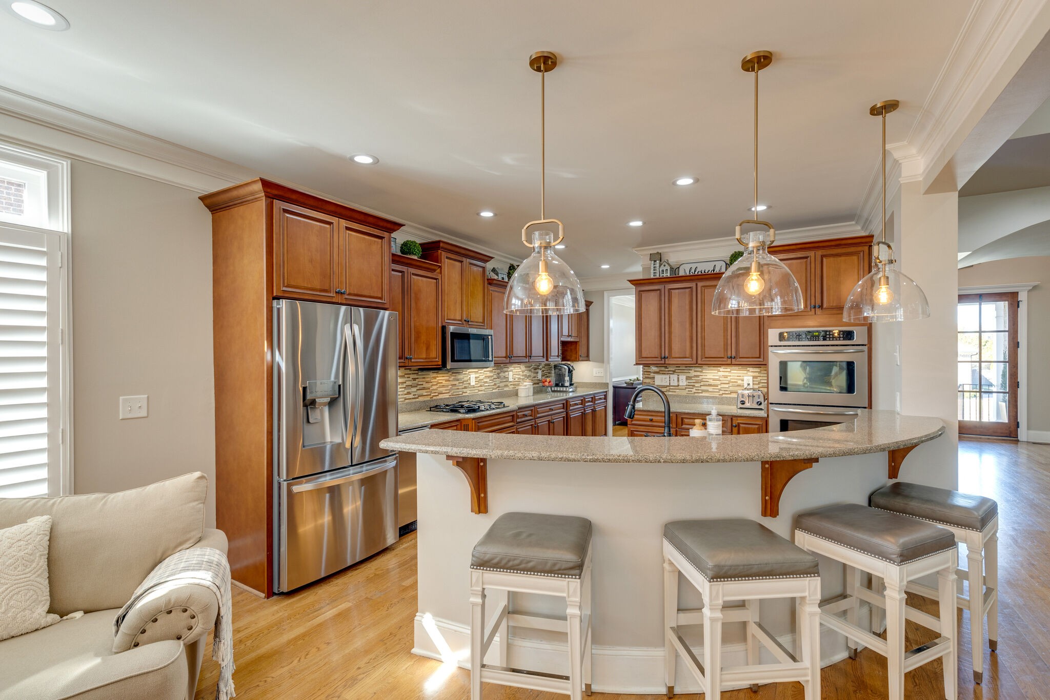 3207 Appian Way Spring Hill, TN 37174 - Photo 13 of 50 a kitchen with stainless steel appliances kitchen island granite countertop a refrigerator a stove a sink dishwasher and white cabinets with wooden floor