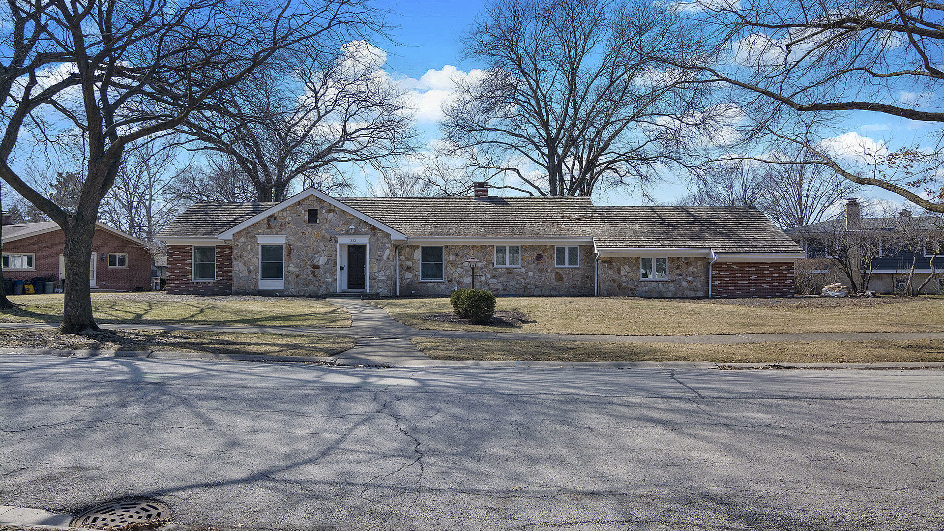 352 Gatesby Road Riverside, IL 60546 - Photo 1 of 18 a view of a house with snow on the road