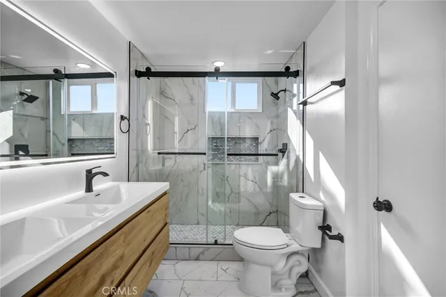 a bathroom with a sink toilet and shower