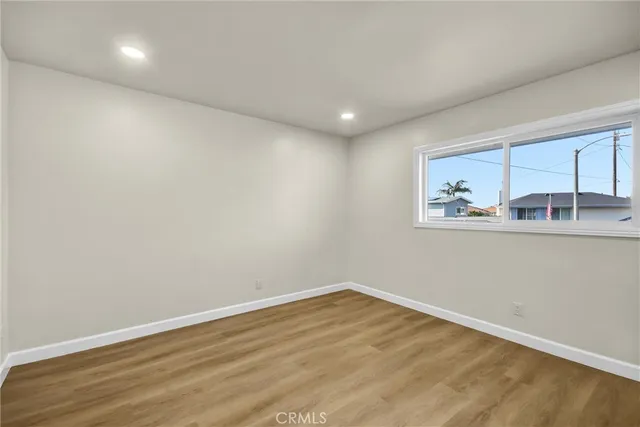a room with wooden floor and window