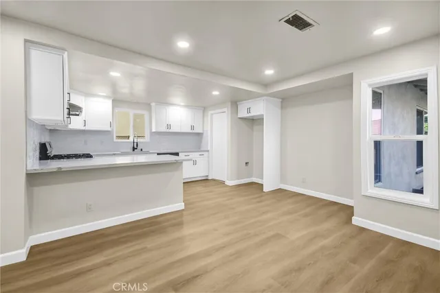 a view of kitchen with granite countertop cabinets and a sink