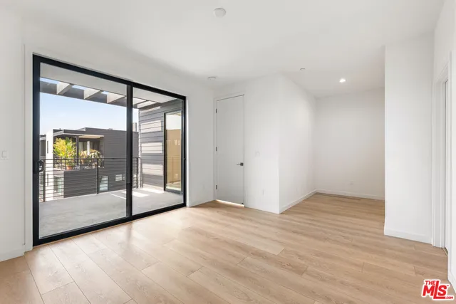a view of an empty room with glass door