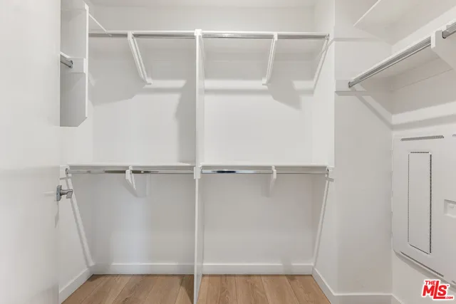 a view of walk in closet with empty racks