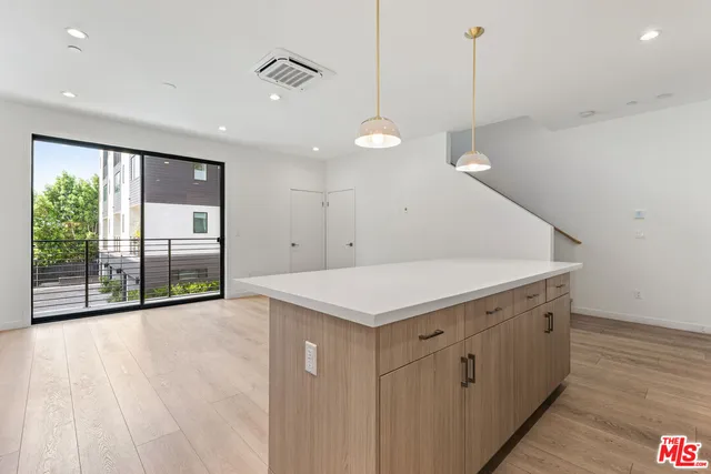 a view of a kitchen with a sink and wooden floor