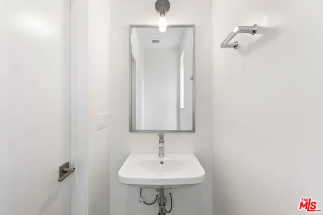 a bathroom with a sink a mirror and shower
