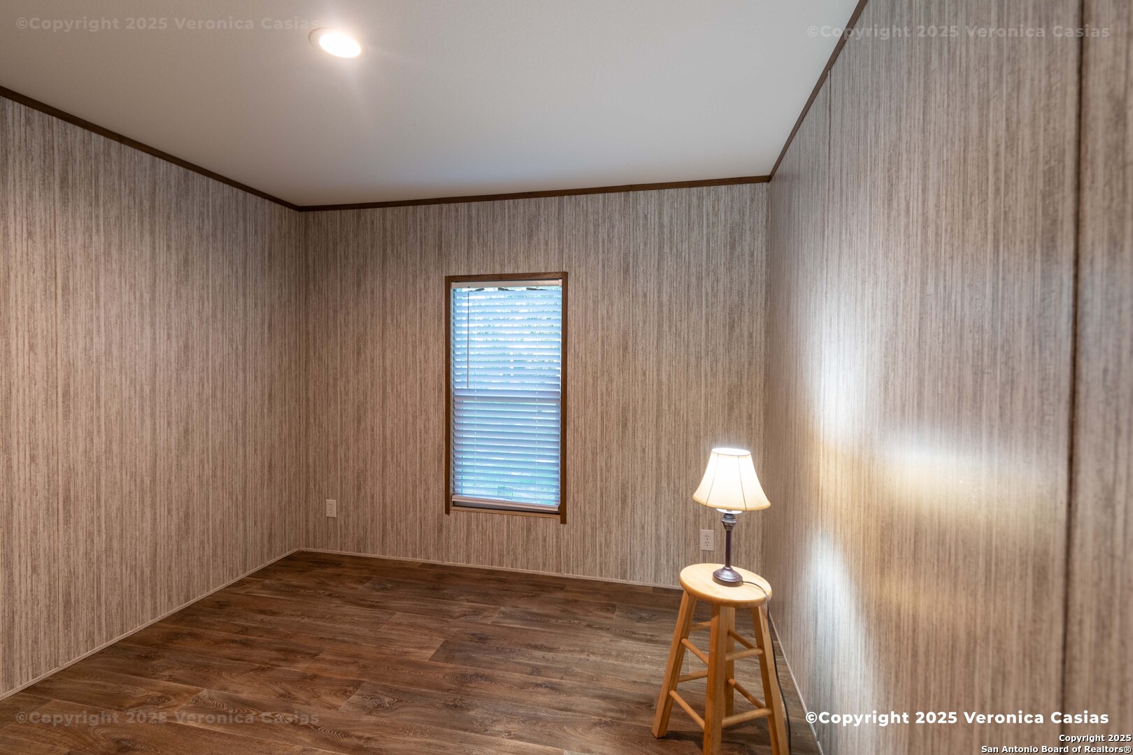 336 County Road 6846 Lytle, TX 78052 - Photo 12 of 20 an empty room with wooden floor windows and fan