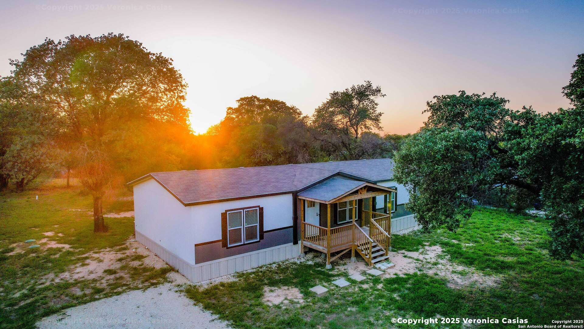 336 County Road 6846 Lytle, TX 78052 - Photo 3 of 20 a view of a house with table and chairs under an umbrella