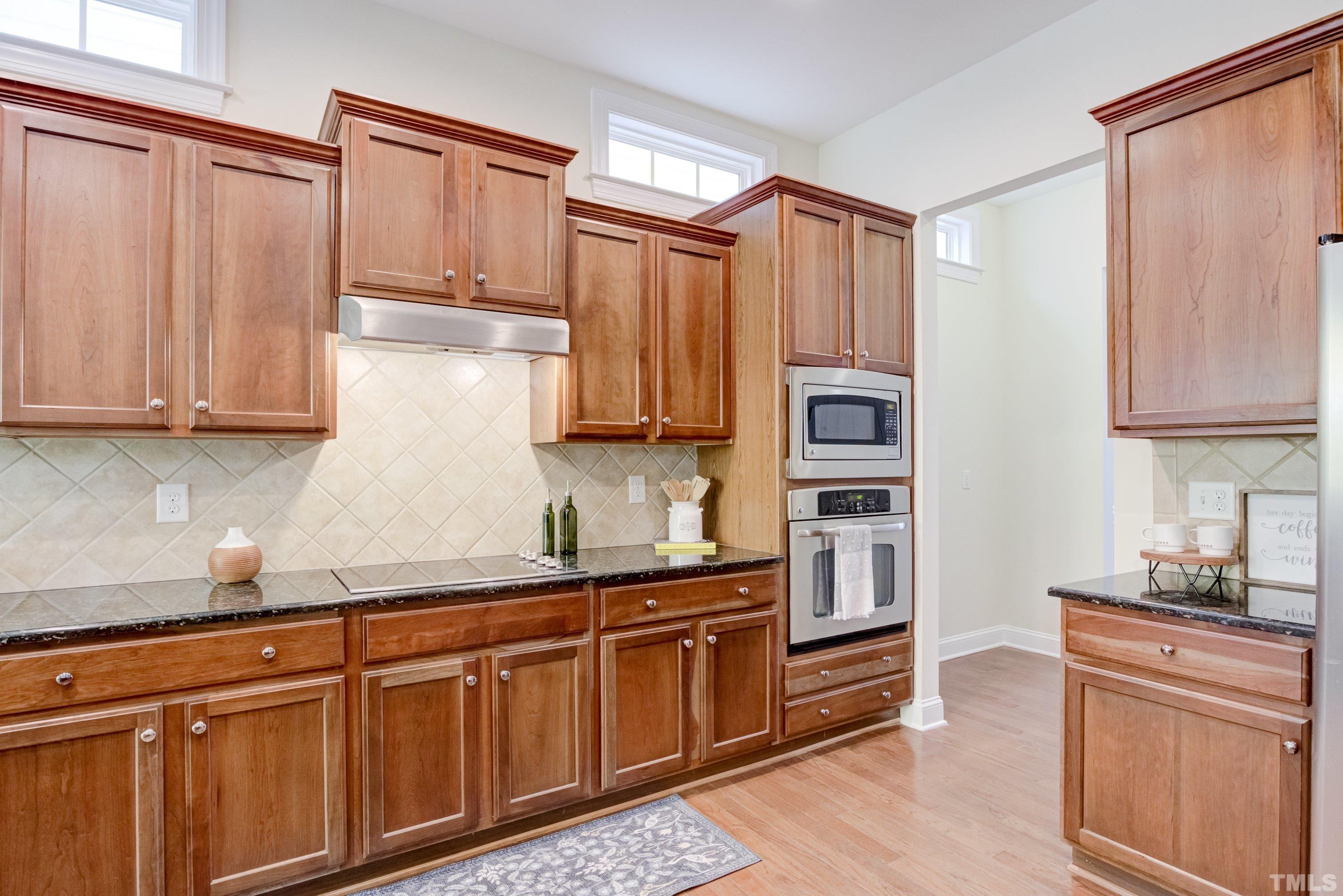 1016 Chapanoke Road Raleigh, NC 27603 - Photo 13 of 49 a kitchen with stainless steel appliances granite countertop a refrigerator and cabinets