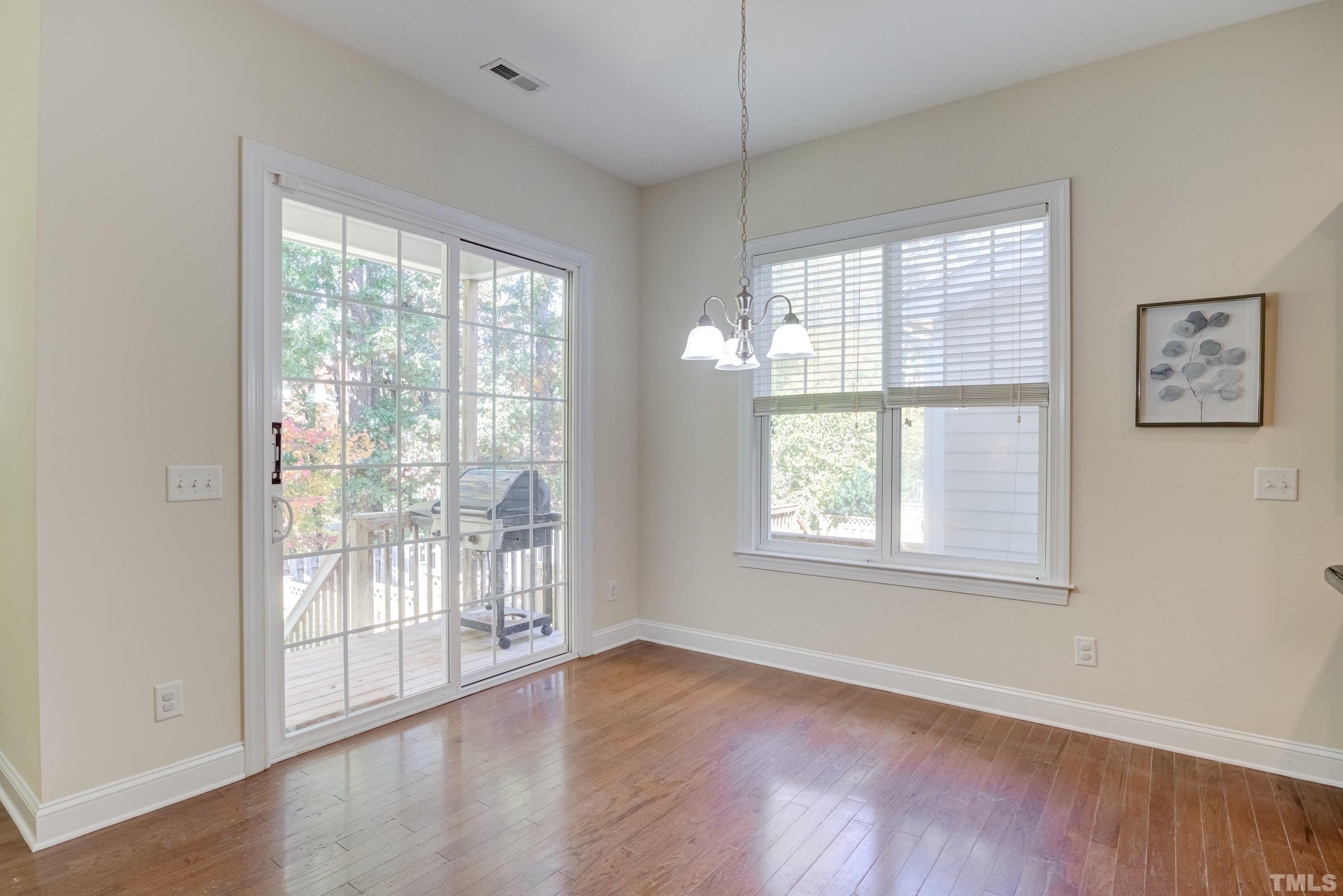 1016 Chapanoke Road Raleigh, NC 27603 - Photo 15 of 49 a view of an empty room with wooden floor and a window
