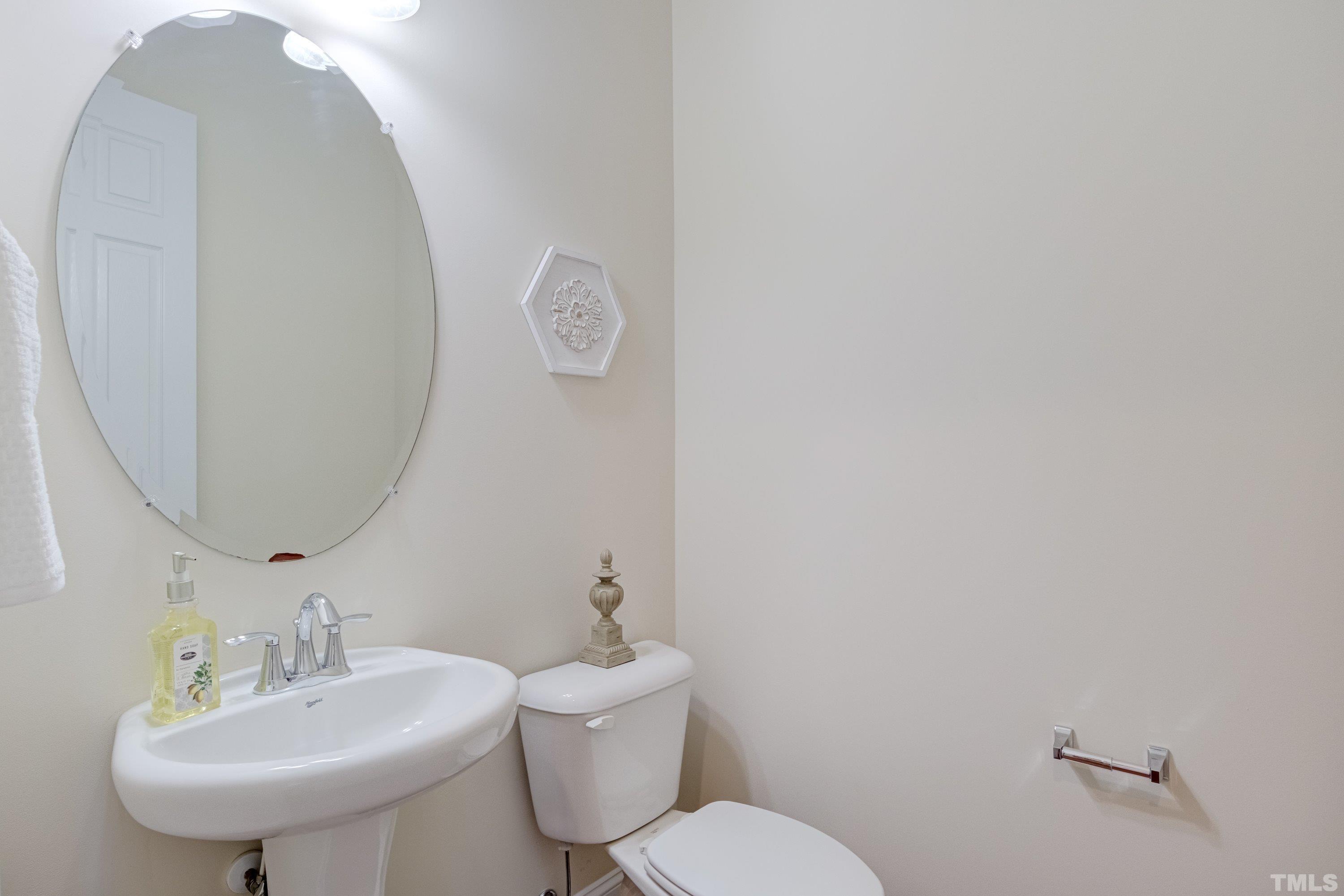 1016 Chapanoke Road Raleigh, NC 27603 - Photo 20 of 49 a bathroom with a toilet sink and mirror