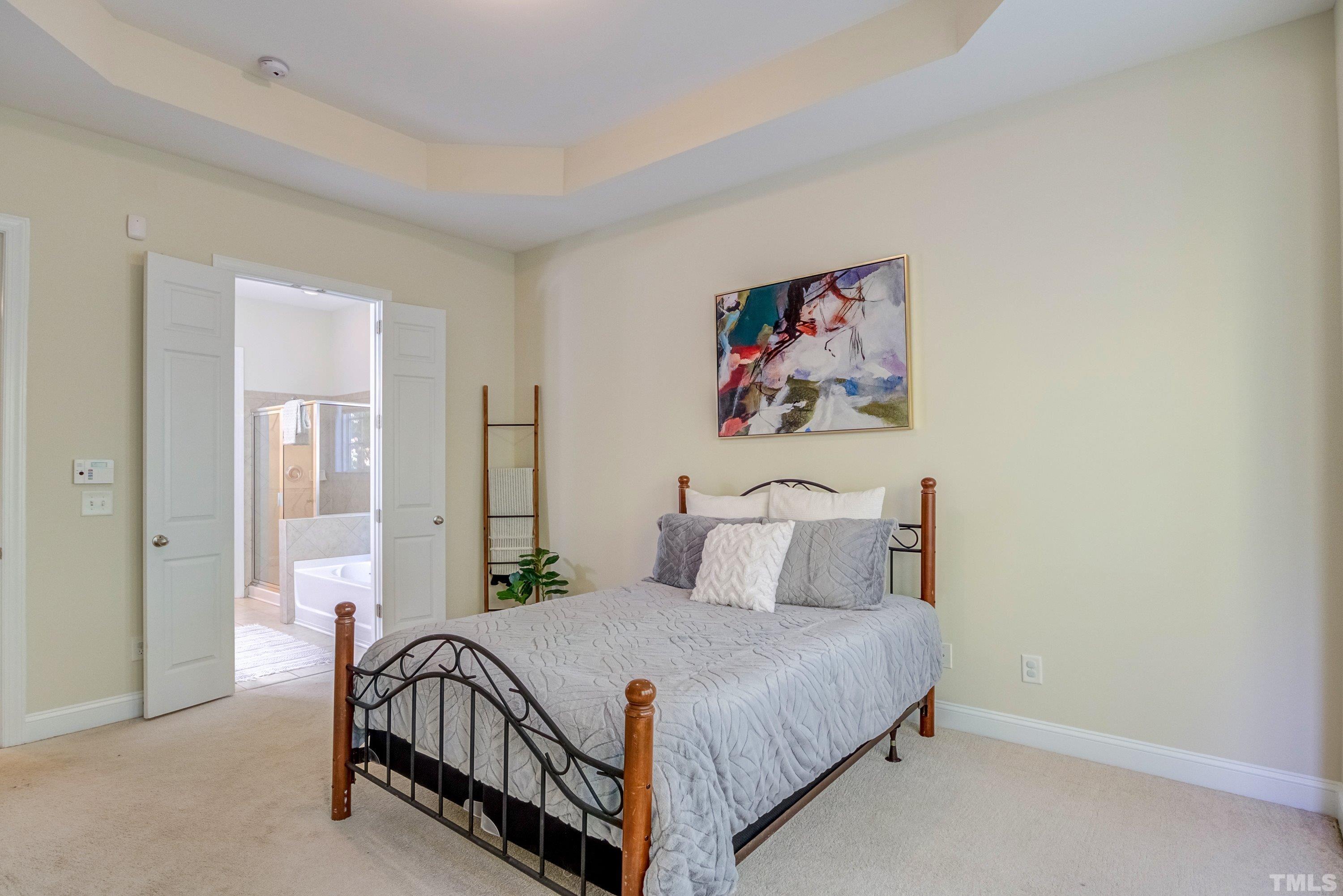 1016 Chapanoke Road Raleigh, NC 27603 - Photo 24 of 49 a bedroom with a bed and a painting on the wall