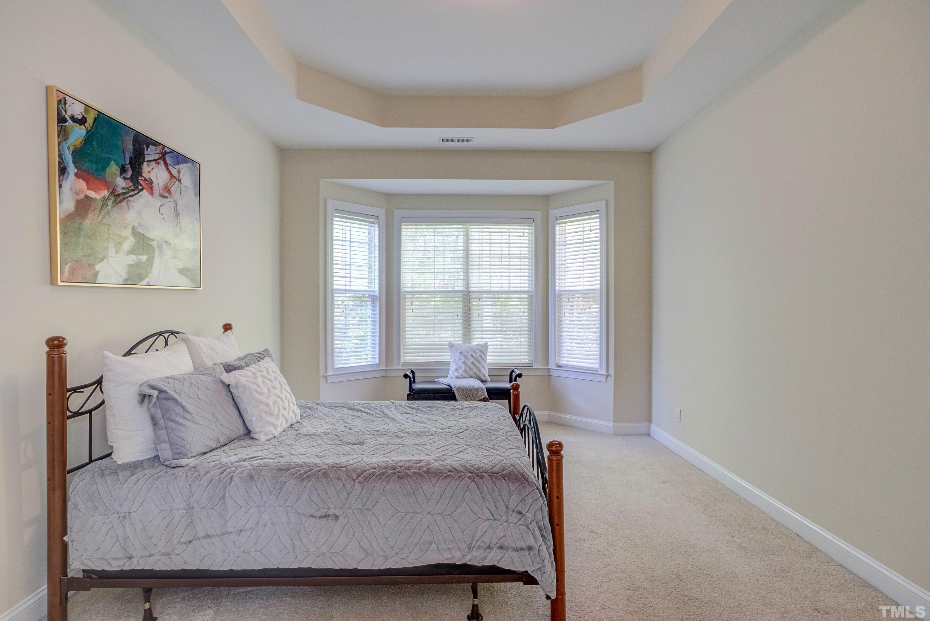 1016 Chapanoke Road Raleigh, NC 27603 - Photo 25 of 49 a bedroom with a bed and a painting on the wall