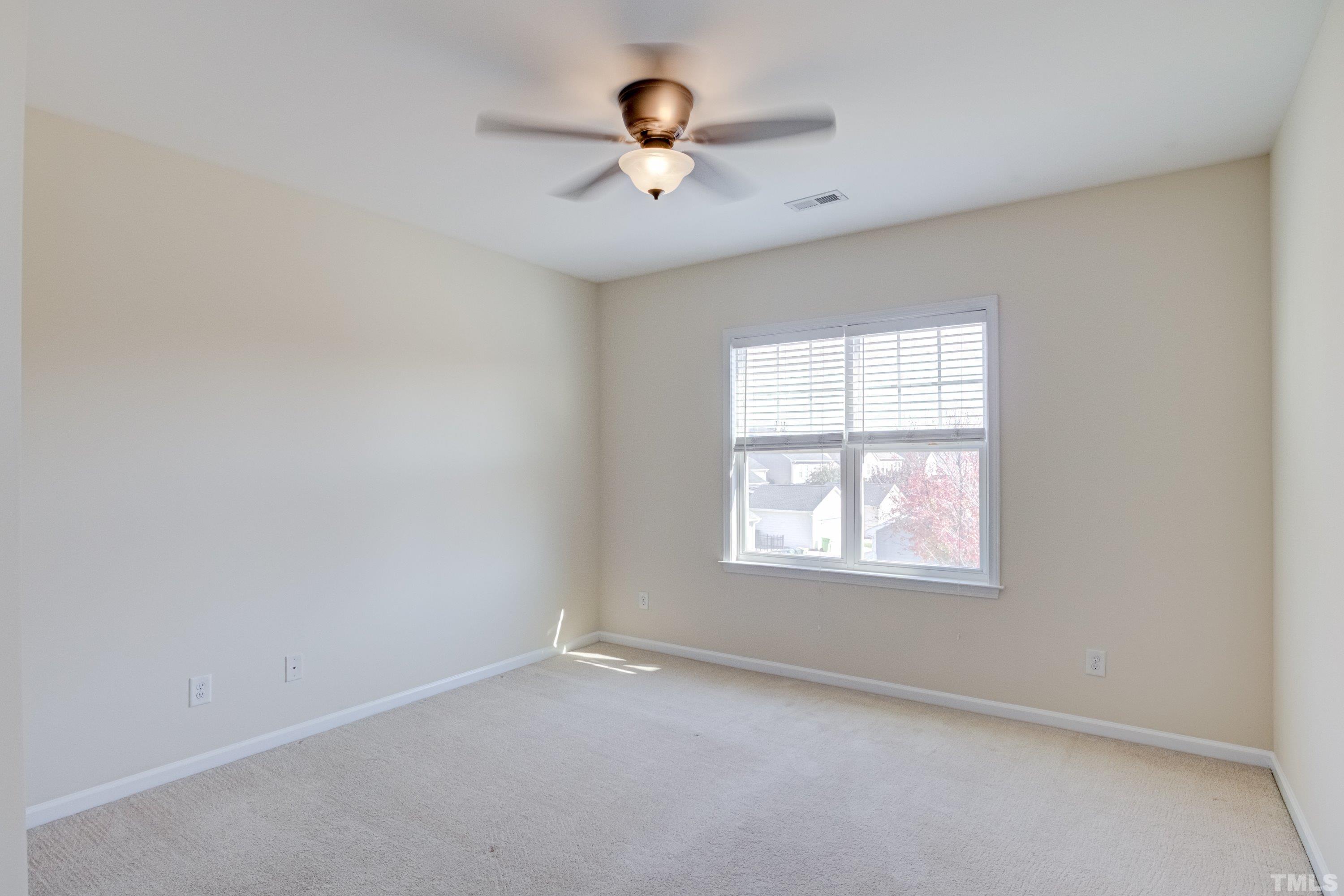 1016 Chapanoke Road Raleigh, NC 27603 - Photo 31 of 49 an empty room with window and hardwood floor