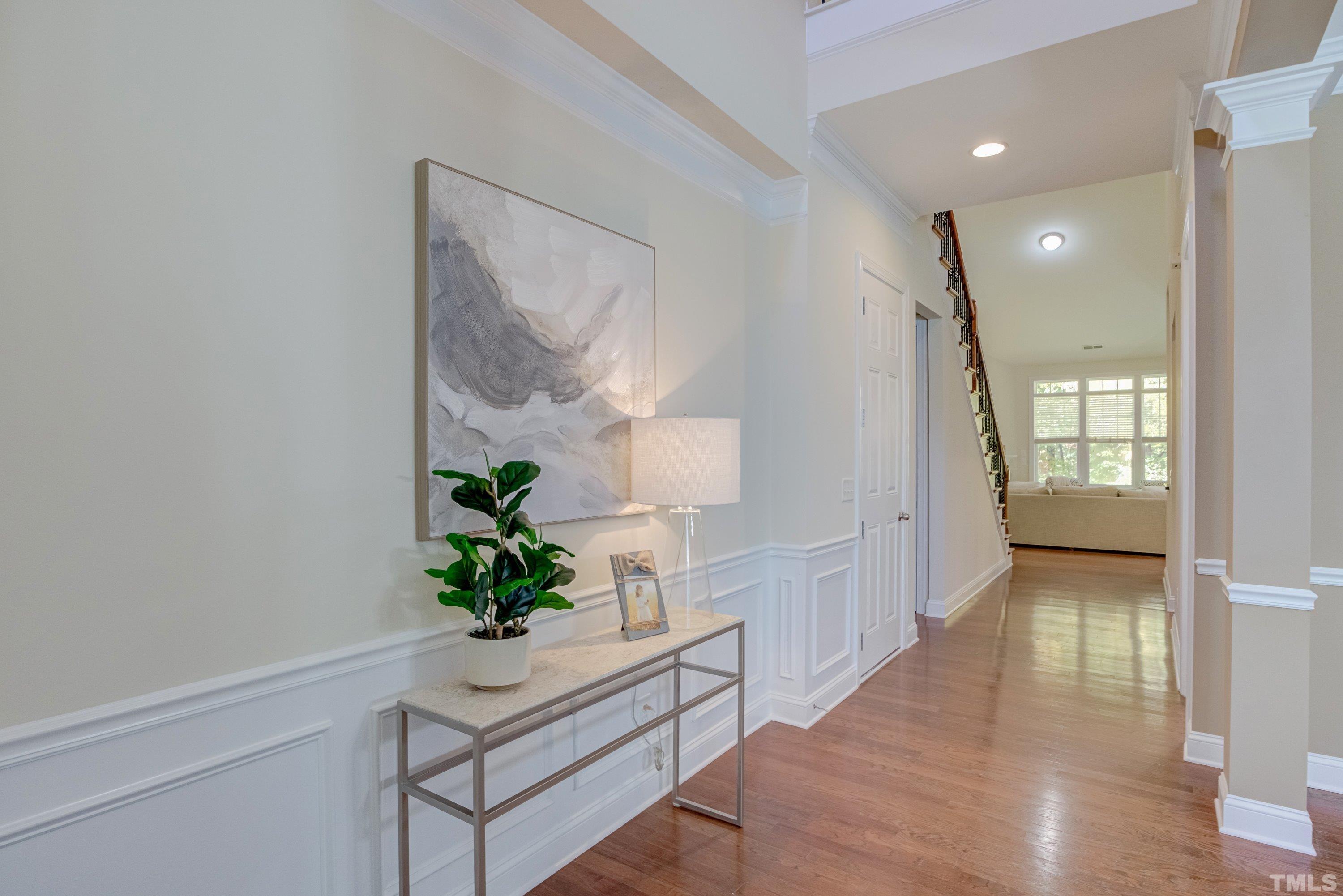 1016 Chapanoke Road Raleigh, NC 27603 - Photo 5 of 49 a view of a hallway with wooden floor and a potted plant