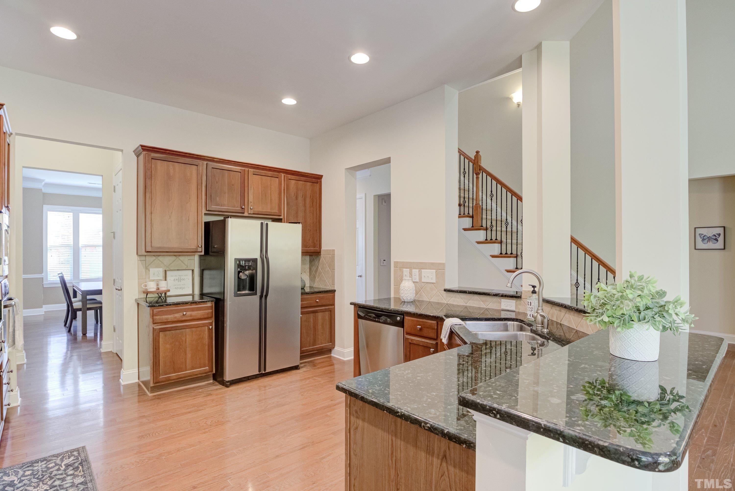 1016 Chapanoke Road Raleigh, NC 27603 - Photo 10 of 49 a kitchen with stainless steel appliances granite countertop a refrigerator a stove and a sink