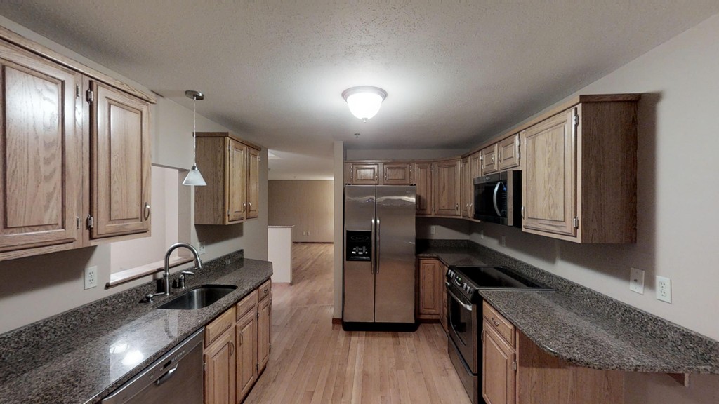 33 Ridgewood Drive, Unit 33 Atkinson, NH 03811 - Photo 1 of 19 a kitchen with stainless steel appliances granite countertop a sink stove and refrigerator