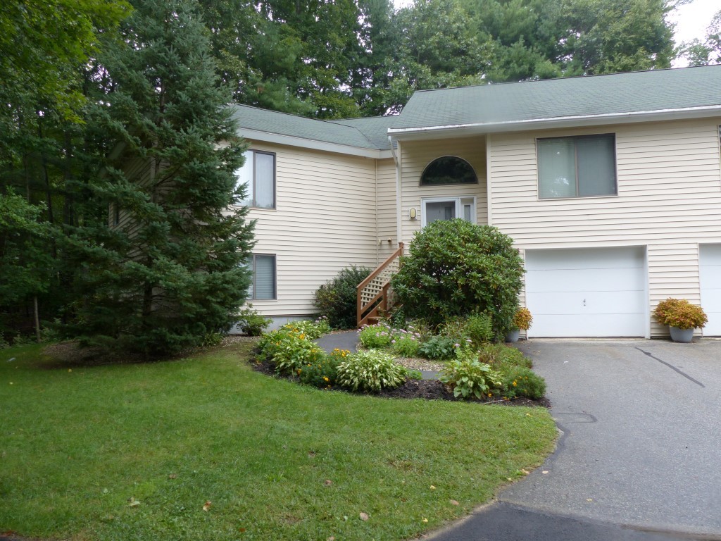33 Ridgewood Drive, Unit 33 Atkinson, NH 03811 - Photo 17 of 19 a front view of a house with a garden