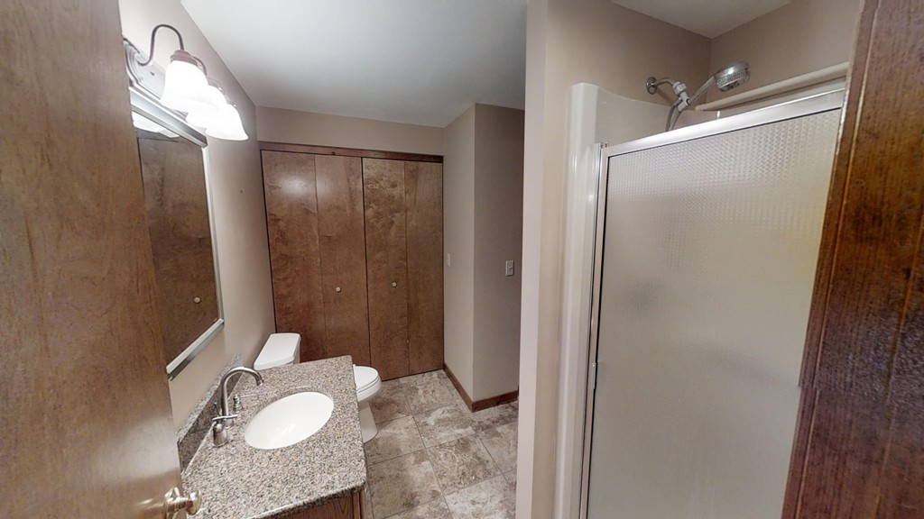 33 Ridgewood Drive, Unit 33 Atkinson, NH 03811 - Photo 7 of 19 a bathroom with a granite countertop sink mirror and shower