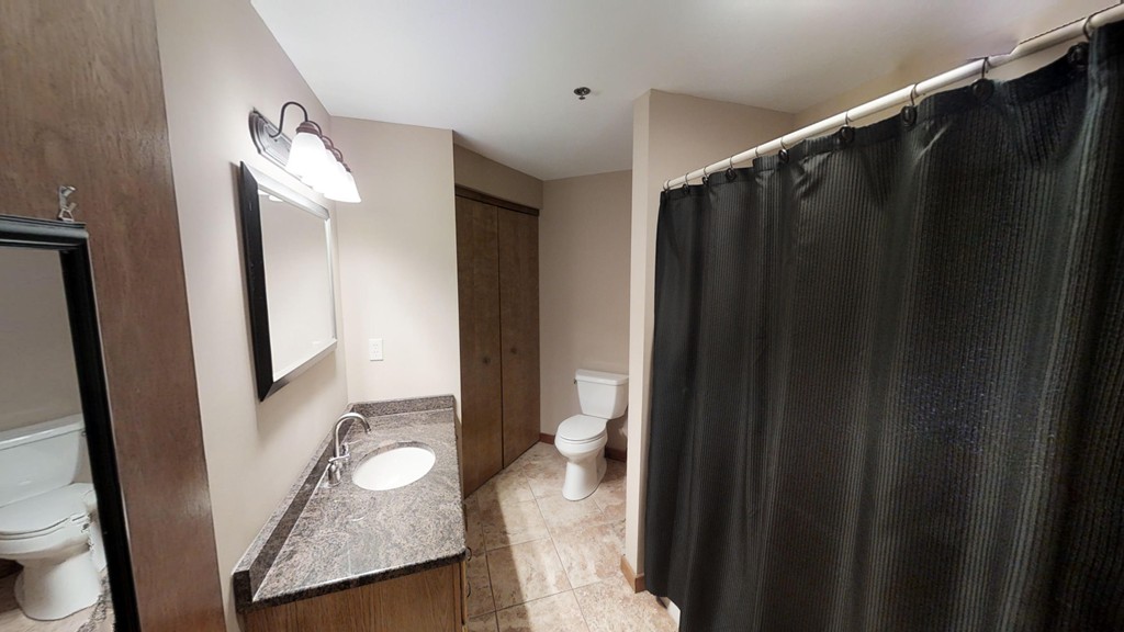 33 Ridgewood Drive, Unit 33 Atkinson, NH 03811 - Photo 10 of 19 a bathroom with a granite countertop sink and a mirror