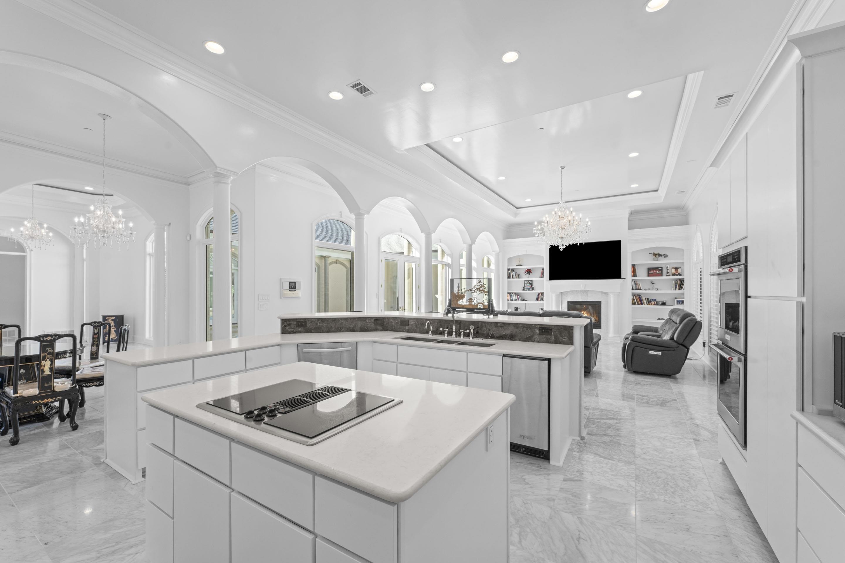 881 Bray Station Road Collierville, TN 38017 - Photo 39 of 40 Kitchen with a chandelier, a tray ceiling, a warm lit fireplace, pendant lighting, and open floor plan