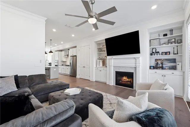 a living room with furniture fireplace and flat screen tv