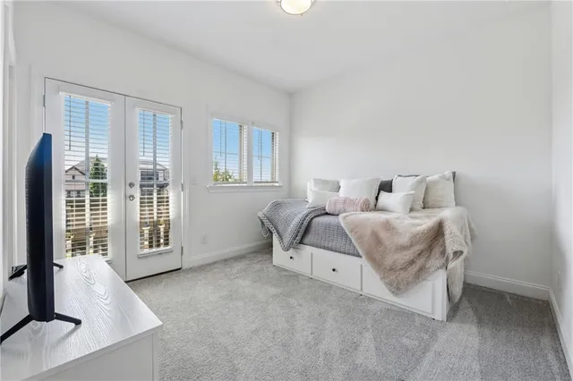 a bedroom with a bed and a large window