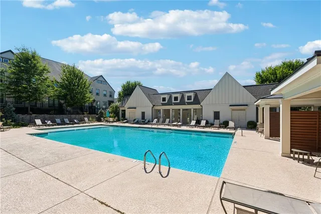 a house view with swimming pool and fire pit